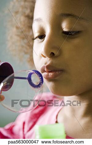 Little girl blowing bubbles View Large Photo Image Stock Photo - Little girl blowing bubbles. Fotosearch