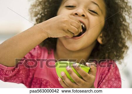 Little girl eating snack View Large Photo Image Stock Image - Little girl eating snack. Fotosearch