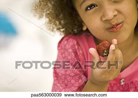 Little girl eating strawberry View Large Photo Image Stock Photo - Little girl eating strawberry. Fotosearch