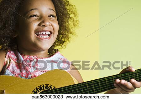 Little girl playing guitar View Large Photo Image Stock Image - Little girl playing guitar. Fotosearch