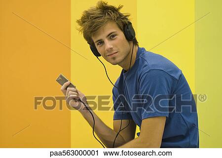 Man listening to Mp3 player View Large Photo Image Stock Image - Man listening to Mp3 player. Fotosearch