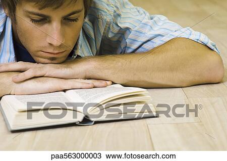Stock Image - Man reading book. Fotosearch