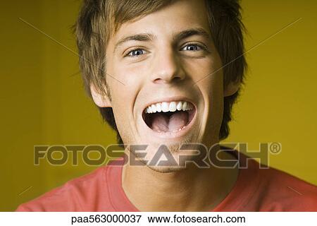 Young man laughing, portrait View Large Photo Image Stock Photo - Young man laughing, portrait. Fotosearch