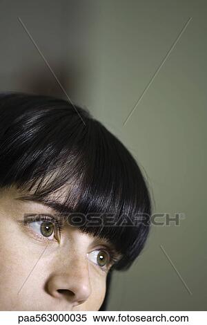 Stock Photography - Young woman looking contemplatively away. Fotosearch