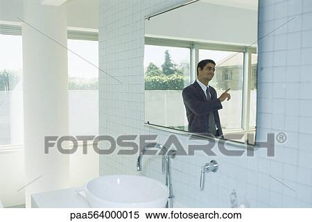 Businessman in bathroom having conversation with person out of frame View Large Photo Image Stock Photography - Businessman in bathroom having conversation with person out of frame. Fotosearch