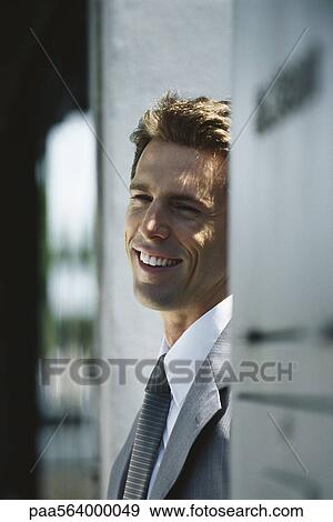 Businessman smiling and looking away, portrait View Large Photo Image Stock Photo - Businessman smiling and looking away, portrait. Fotosearch