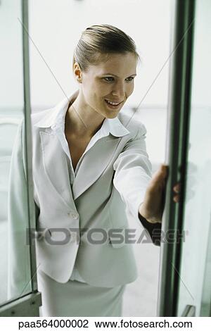 Businesswoman entering building View Large Photo Image Stock Image - Businesswoman entering building. Fotosearch