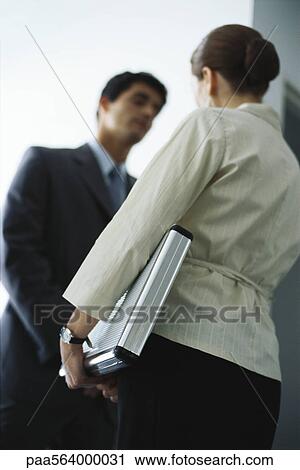 Businesswoman in conversation with colleague, low angle view View Large Photo Image Stock Image - Businesswoman in conversation with colleague, low angle view. Fotosearch