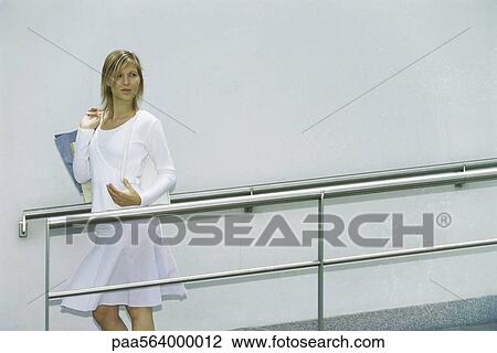 Woman carrying shopping bag over shoulder View Large Photo Image Stock Image - Woman carrying shopping bag over shoulder. Fotosearch