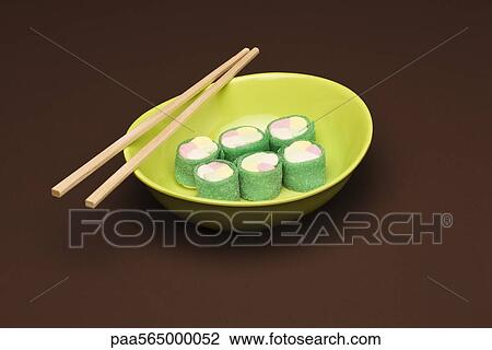 Stock Image - Food concept, candy rolled to look like maki sushi. Fotosearch