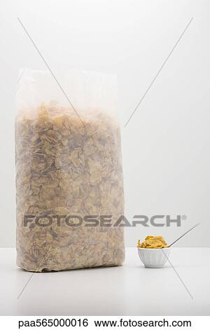 Stock Photograph - Food concept, cereal bag with small bowl of cereal. Fotosearch