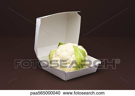 Stock Image - Food concept, fresh cauliflower inside fast food container. Fotosearch