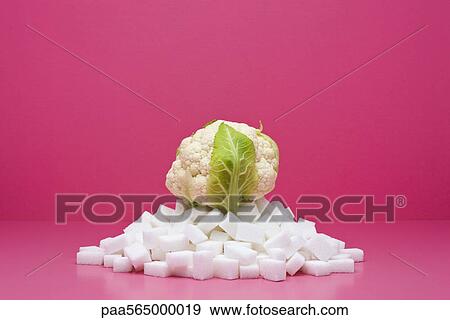 Food concept, fresh cauliflower on top of pile of sugarcubes View Large Photo Image Stock Photo - Food concept, fresh cauliflower on top of pile of sugarcubes. Fotosearch