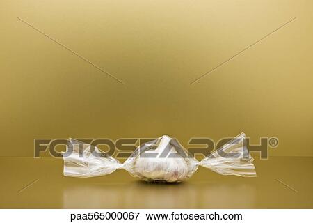 Food concept, head of garlic inside of cellophane candy wrapper View Large Photo Image Stock Photo - Food concept, head of garlic inside of cellophane candy wrapper. Fotosearch