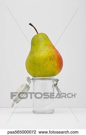 Food concept, pear on top of small glass jar View Large Photo Image Stock Image - Food concept, pear on top of small glass jar. Fotosearch