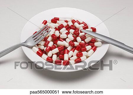 Stock Image - Food concept, plate full of pills. Fotosearch