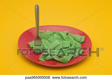Food concept, plate of green gummy candy arranged like pasta View Large Photo Image Stock Photo - Food concept, plate of green gummy candy arranged like pasta. Fotosearch