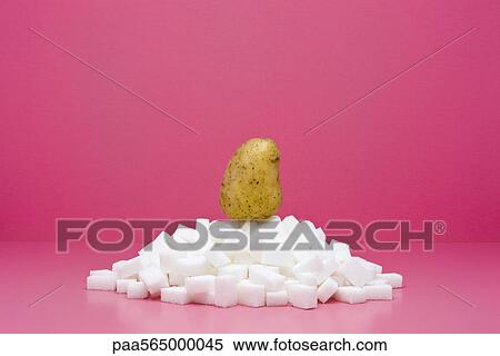 Food concept, potato on top of pile of sugar cubes View Large Photo Image Stock Photography - Food concept, potato on top of pile of sugar cubes. Fotosearch