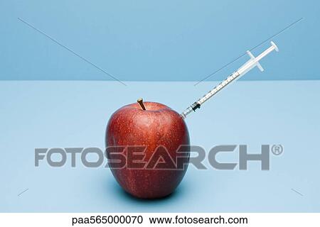 Food concept, syringe sticking out of apple View Large Photo Image Stock Image - Food concept, syringe sticking out of apple. Fotosearch