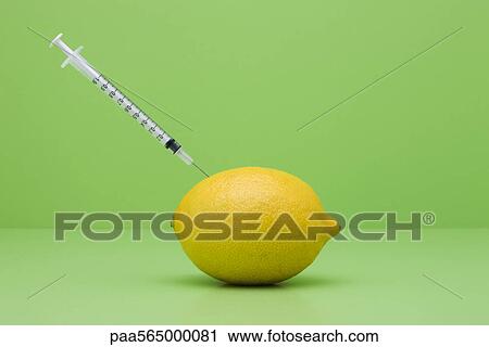 Food concept, syringe sticking out of lemon View Large Photo Image Stock Image - Food concept, syringe sticking out of lemon. Fotosearch