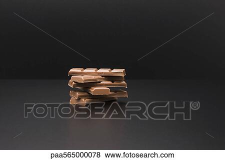 Stack of milk chocolate bars View Large Photo Image Stock Photo - Stack of milk chocolate bars. Fotosearch