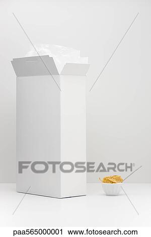 Stock Image - White cereal box and small bowl of cereal. Fotosearch