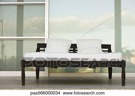 Bed on outdoor patio at resort View Large Photo Image Picture - Bed on outdoor patio at resort. Fotosearch