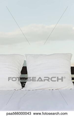 Pillows on bed, clouds in background View Large Photo Image Stock Image - Pillows on bed, clouds in background. Fotosearch