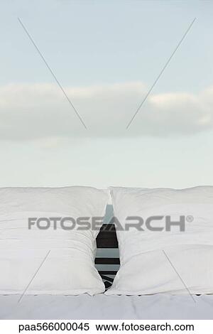 Pillows on bed, clouds in background View Large Photo Image Stock Photography - Pillows on bed, clouds in background. Fotosearch