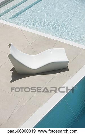 Poolside deckchair, high angle view View Large Photo Image Stock Photo - Poolside deckchair, high angle view. Fotosearch