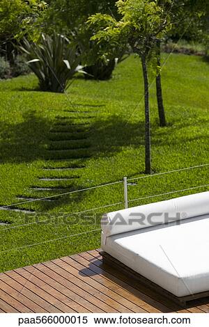 Sunbathing bed on deck at resort View Large Photo Image Stock Photography - Sunbathing bed on deck at resort. Fotosearch