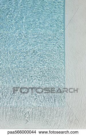 Sunlight refracted on water in swimming pool View Large Photo Image Picture - Sunlight refracted on water in swimming pool. Fotosearch