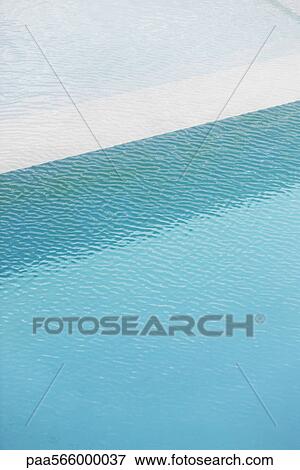 Stock Photo - Swimming pool deep end separated from shallow pool by ledge. Fotosearch