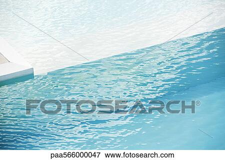 Stock Photo - Swimming pool with ledge separating deep and shallow ends. Fotosearch