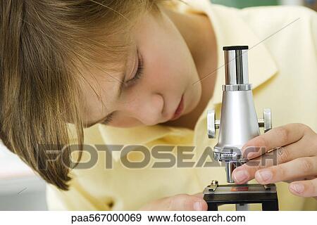 Boy adjusting slide on microscope View Large Photo Image Stock Photo - Boy adjusting slide on microscope. Fotosearch