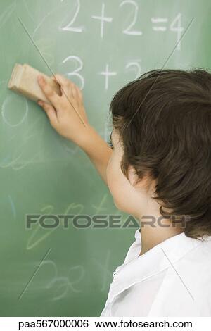 Stock Photograph - Boy erasing blackboard. Fotosearch