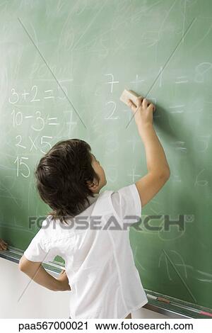 Boy erasing classroom blackboard, rear view View Large Photo Image Stock Image - Boy erasing classroom blackboard, rear view. Fotosearch