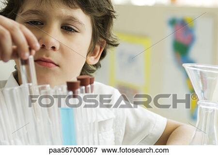 Boy removing test tube from rack, close-up View Large Photo Image Stock Photo - Boy removing test tube from rack, close-up. Fotosearch