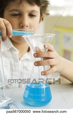 Boy transferring liquid from test tube to beaker using funnel View Large Photo Image Stock Image - Boy transferring liquid from test tube to beaker using funnel. Fotosearch