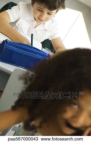 Elementary students working at desks View Large Photo Image Stock Image - Elementary students working at desks. Fotosearch