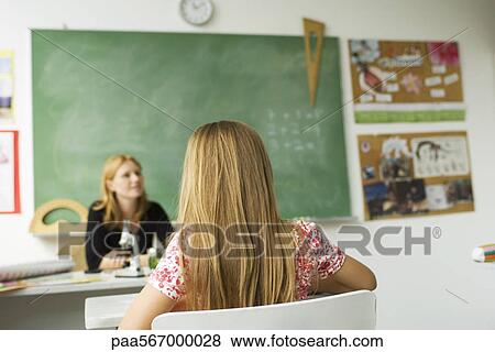 Stock Photo - Girl sitting attentively in elementary classroom. Fotosearch