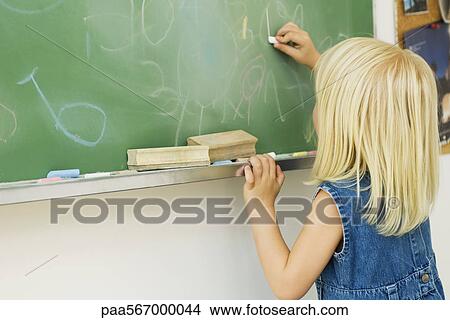 Little girl drawing on blackboard View Large Photo Image Picture - Little girl drawing on blackboard. Fotosearch