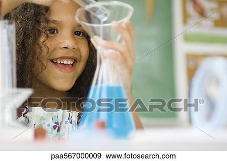 Stock Photo - Little girl transferring liquid from test tube to beaker. Fotosearch