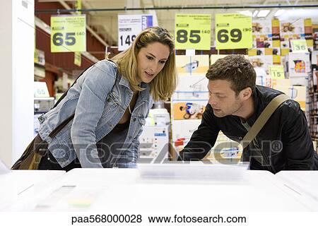 Couple shopping for household appliance View Large Photo Image Stock Photo - Couple shopping for household appliance. Fotosearch