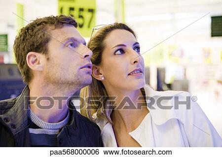 Couple together in store View Large Photo Image Stock Photograph - Couple together in store. Fotosearch