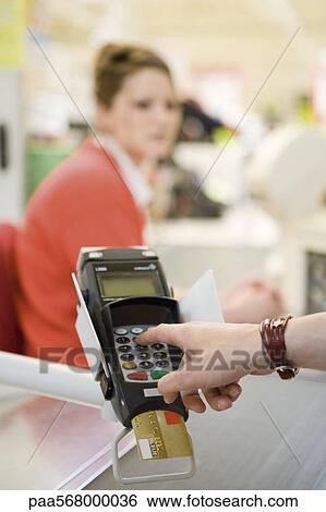 Customer entering pin into credit card reader keypad View Large Photo Image Stock Photograph - Customer entering pin into credit card reader keypad. Fotosearch