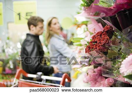 Flower bouquets at flower shop, couples browsing in background View Large Photo Image Stock Image - Flower bouquets at flower shop, couples browsing in background. Fotosearch