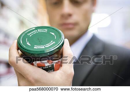 Man reading label on jar of jam View Large Photo Image Stock Image - Man reading label on jar of jam. Fotosearch