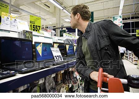 Man shopping for laptop computers View Large Photo Image Picture - Man shopping for laptop computers. Fotosearch