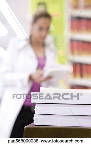 Reams of paper in stack, shopper in background View Large Photo Image Stock Photo - Reams of paper in stack, shopper in background. Fotosearch